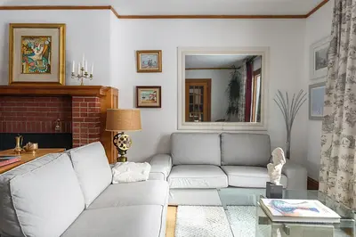 a living room with a couch and a table at Maison Sherman's house in Scotstown