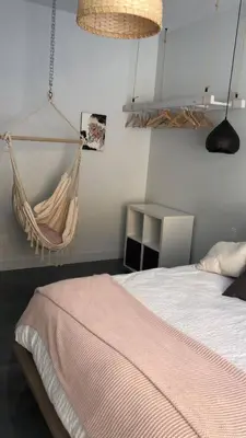 a bedroom with a hammock hanging from the wall at Magnifique Chalet En Montagne in Shefford
