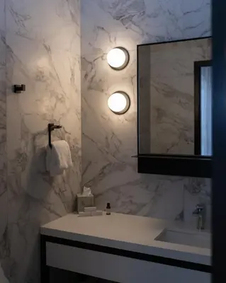 a bathroom with a sink and a mirror at Le Petit Hotel Notre Dame in Montréal