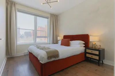 a bedroom with a bed with a large window at Rozenhaus Hotel Montreal in Montréal