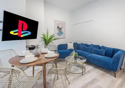 a living room with a blue couch and a table at Luxurious 3BD Apt in heart of downtown 5 min walk to Bell Center in Montréal