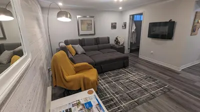 a living room with a couch and a tv at Simplement l’Harmonie à Chambly in Chambly