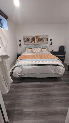 a bedroom with a large bed in a room at Simplement l’Harmonie à Chambly in Chambly