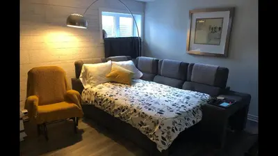 a living room with a couch and a chair at Simplement l’Harmonie à Chambly in Chambly
