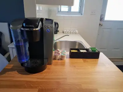 a coffee maker sitting on a counter next to a sink at Bright and Spacious Studio Apartment in Montréal