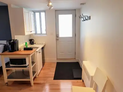 a small kitchen with a sink and a microwave at Bright and Spacious Studio Apartment in Montréal