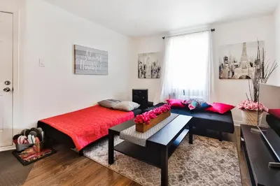 a bedroom with a bed and a desk in a room at Comfortable 2-BEDROOM APARTMENT - Free and plentiful PARKING - 10 minutes to AIRPORT and 15 minutes to DOWNTOWN Montreal - Near Popular Waterfront Restaurants - located in Beautiful Lachine in Montréal