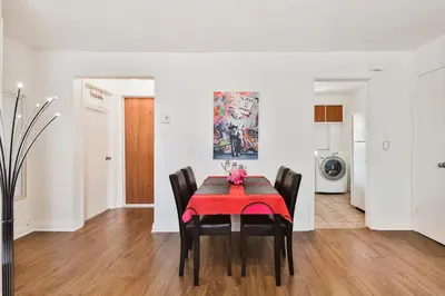 a dining room with a red table and chairs at Comfortable 2-BEDROOM APARTMENT - Free and plentiful PARKING - 10 minutes to AIRPORT and 15 minutes to DOWNTOWN Montreal - Near Popular Waterfront Restaurants - located in Beautiful Lachine in Montréal
