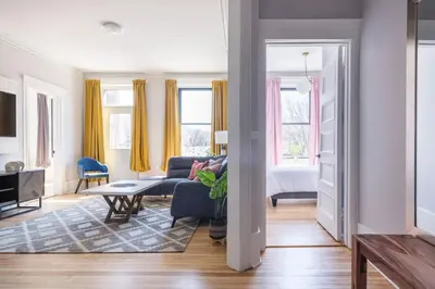 a living room with a couch and a table at The Parkview By MTLVacationRentals in Montréal