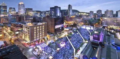 a large crowd of people in a city at night at The Parkview By MTLVacationRentals in Montréal