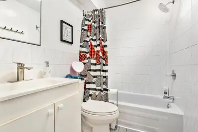 a bathroom with a toilet and a sink at 250 METERS to METRO BERRI UQAM - Spacious fully equipped APARTMENTS - 1 FREE PARKING per unit - in-unit Washer & Dryer - fully stocked KITCHEN - WORKSPACE PROVIDED - FAST WIFI - 5 minute walk to the FAMOUS ST CATHERINE & ST DENIS STREET in Montréal