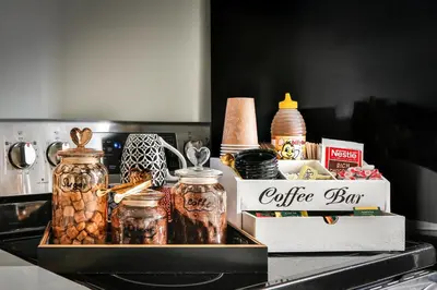 a tray filled with jars and a box of coffeeaband at 250 METERS to METRO BERRI UQAM - Spacious fully equipped APARTMENTS - 1 FREE PARKING per unit - in-unit Washer & Dryer - fully stocked KITCHEN - WORKSPACE PROVIDED - FAST WIFI - 5 minute walk to the FAMOUS ST CATHERINE & ST DENIS STREET in Montréal