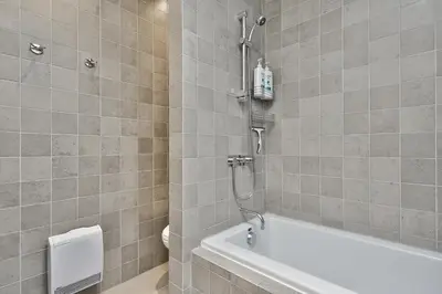 a bathroom with a shower and a bath tub at STUNNING full APARTMENTS - stocked KITCHENS - WASHER & DRYERS - WORKSPACE PROVIDED - FAST WIFI - LOCATED on the FAMOUS ST Denis street - Near METRO MONT ROYAL in Montréal