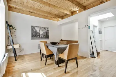 a dining room with a table and chairs at STUNNING full APARTMENTS - stocked KITCHENS - WASHER & DRYERS - WORKSPACE PROVIDED - FAST WIFI - LOCATED on the FAMOUS ST Denis street - Near METRO MONT ROYAL in Montréal