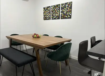 a wooden table with chairs and a bowl of fruit on it at Fantastique 3 chambres modernes au cœur de la ville in Montréal