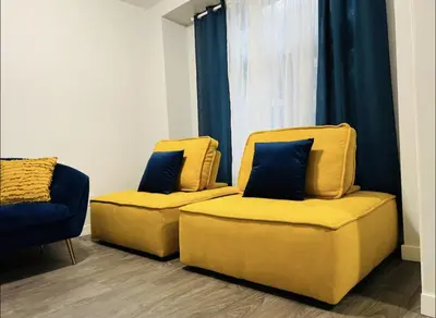 two yellow chairs sitting in a room with a window at Fantastique 3 chambres modernes au cœur de la ville in Montréal