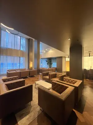 a lobby with couches and chairs in a building at Beautiful one bedroom downtown Condo with pool and free parking in Montréal