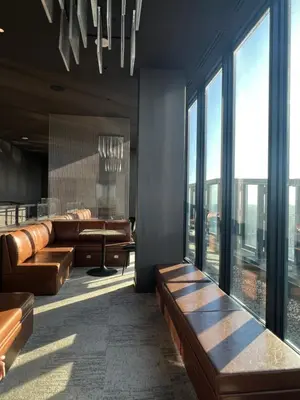 a lobby with leather furniture and large windows at Beautiful one bedroom downtown Condo with pool and free parking in Montréal