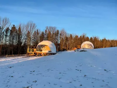 two domes in a field in the snow at Mi-clos - luxury pods with private jacuzzi and sauna in Orford