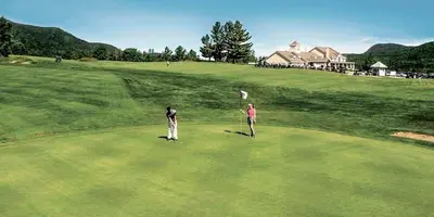 two people standing on a green golf course at Mi-clos - luxury pods with private jacuzzi and sauna in Orford