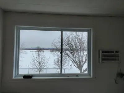 a window in a room with a view of a tree at Motel Sainte Catherine in Sainte-Catherine